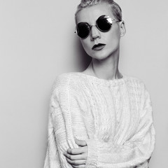 Sensual lady in warm sweater and stylish glasses