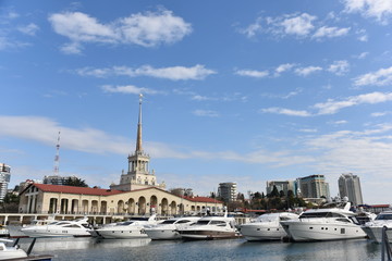 Fototapeta na wymiar Yachts moored on the waterfront of the city a Sunny summer day. District Sochi, Russia