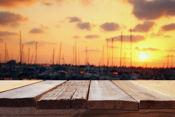 Plakat table in front of abstract blurred yachts at sunset