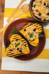 Pumpkin Acorn Stuffed with Quinoa, Nuts and Dried Fruit. Selective focus.