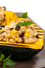 Pumpkin Acorn Stuffed with Quinoa, Nuts and Dried Fruit. Selective focus.