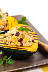 Pumpkin Acorn Stuffed with Quinoa, Nuts and Dried Fruit. Selective focus.