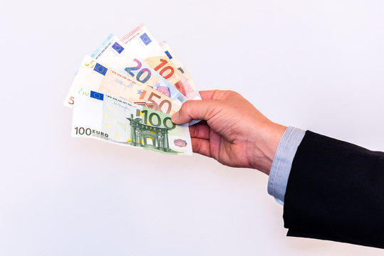 Male in suit holds Euro banknotes in cash in his hands