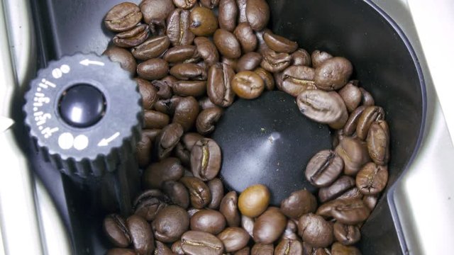 coffee grains are milled in the coffee machine for preparation of fragrant coffee