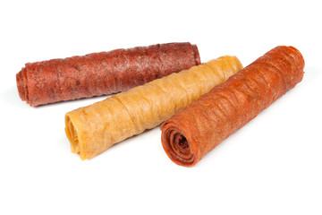 Candied fruit twisted in roll isolated on white background. Homemade sweetness of dried fruit.