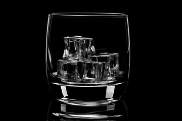 Empty glass filled with ice cubes. Nice reflection From the glass.