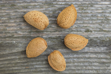 nuts almonds in shells  on a old wooden table.