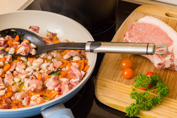 Small pieces of pork cooked in a pan