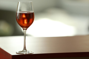 Glass with red wine on table
