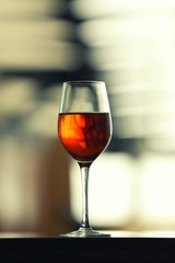 Glass with red wine on table