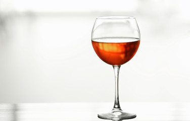 Glass with red wine on table