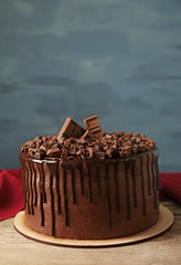 Tasty chocolate cake on grey wall background