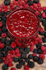 Glass of delicious blackberry and raspberry milk shake, closeup