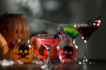 Tasty cocktail with decor for Halloween, on blurred background