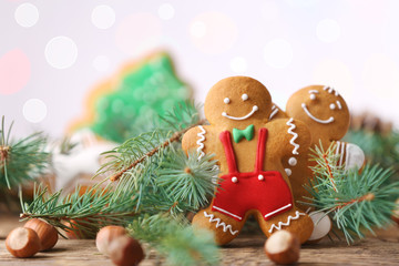 Composition of tasty Christmas cookies and natural decor on wooden table