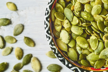 Pumpkin seeds in a ceramic bowl