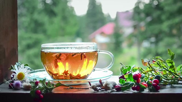 Cup of tea on the window sill. Hot tea. Tea leaves at the bottom of the cup. Delicious tea. Tea is waiting for ... It's tea time!