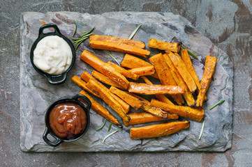 Sweet Potato Fries Top View on Slate with Ketchup and Mayonnaise