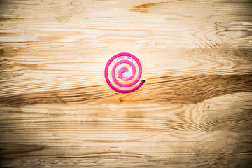 Mosquito coil is mosquito-repelling incense On the wooden floor.