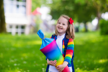 Little child with candy cone on first school day