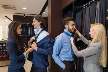 Handsome Business Man Trying Suit Clothes Woman Assistant Help Knotting the Necktie Fashion Shop, Customers Choosing In Retail Store Young People Shopping Formal Wear