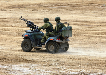 Fototapeta premium Soldiers on a quad bike in exploration