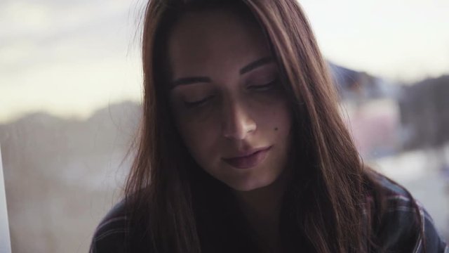 Close-up footage of an attractive caucasian girl reads a book,  panoramic shot. 