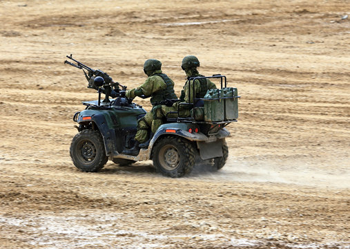 Soldiers on a quad bike in exploration
