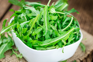 Fresh Arugula on an old wooden table