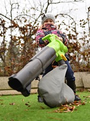 girl with leaf blower