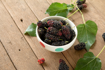 Mulberry is healthy fruit for make juice put on wooden desk back