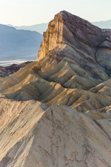 Last rays of sun shining on a mountain in Death Valley National Park, CA, USA