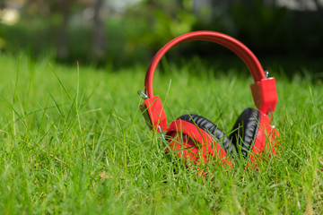 Naklejka premium Headphones on grass, selective focus.