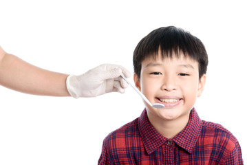 Dentist checking young asian boy teeth