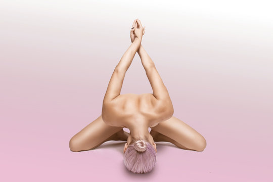 beautiful naked yoga girl on a pink background