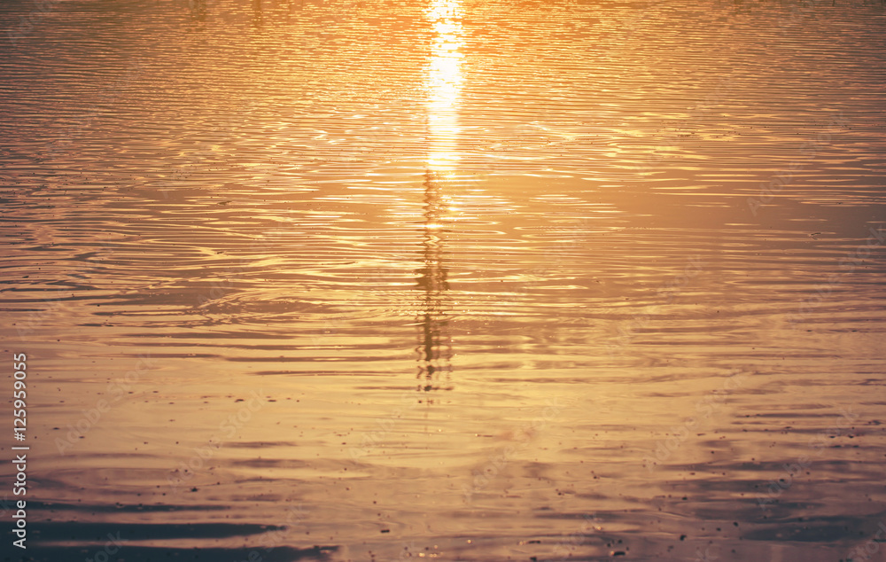 Wall mural water surface reflection sunset golden light