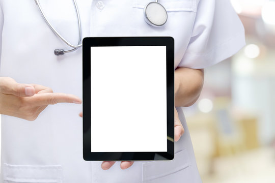 Male doctor holding and pointing blank digital tablet isolated o