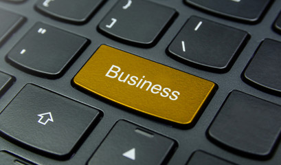 Business Concept: Close-up the Business button on the keyboard and have Gold, Yellow color button isolate black keyboard