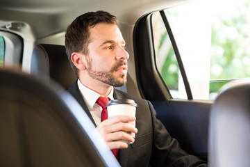 Drinking some coffee while riding a car