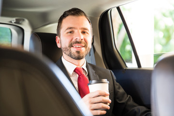 Happy Hispanic man drinking some coffee