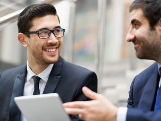 Two businessmen talking outdoors