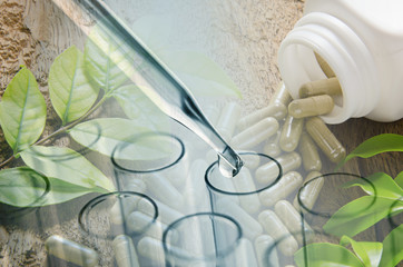 double exposure of science laboratory test tubes and herbal caps