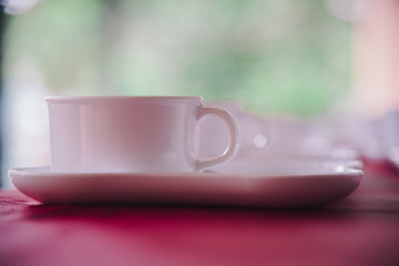 Many rows of white ceramic coffee or tea cups.