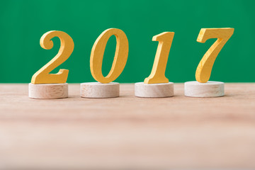 gold wooden font year 2017 on wood table