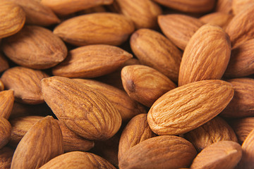 Almonds background. Pile of selected almonds close-up. For vegetarians.