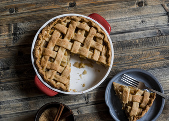 Rustic apple pie on wooden table, top view.