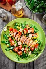 Fresh salad with chicken breast, arugula and tomato