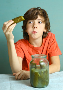 preteen boy eat marinated salted cucumber