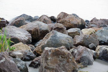the stones on the beach under the incoming wave