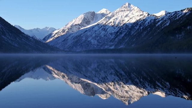 Lower Multinskoe lake in the Altai Mountains  on blue sky background.